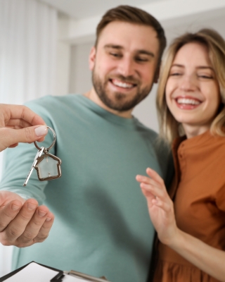 Realtor Giving Keys to the Couple